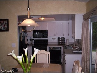 8056 Pelican Road Fort Myers, FL 33967 - Photo 5 of 5 a kitchen with a refrigerator and a stove top oven