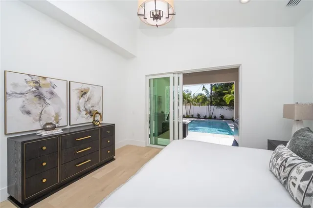a bathroom with double vanity sink a mirror and a bathtub