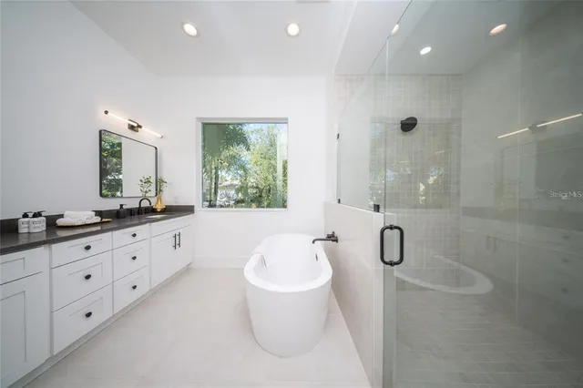 a bathroom with a toilet a sink a vanity and mirror