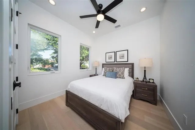 a bedroom with a bed and a night stand