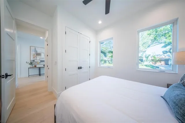 a bedroom with a large bed and a chandelier