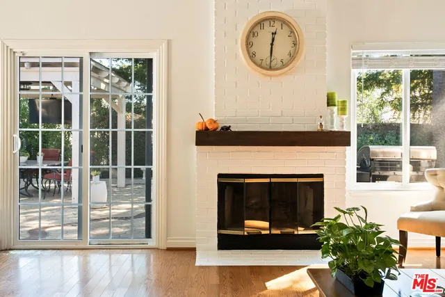 a living room with a fireplace and a large window