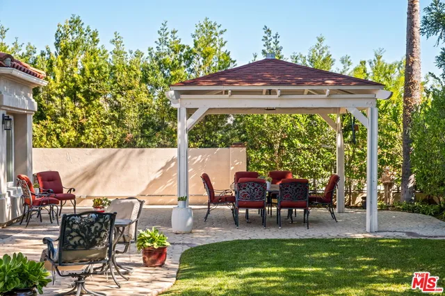 a view of swimming pool with lawn chairs and a yard