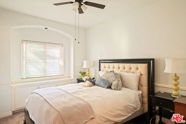 a bedroom with a bed and a night stand