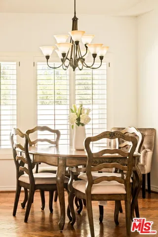 a view of a dining room with furniture and wooden floor