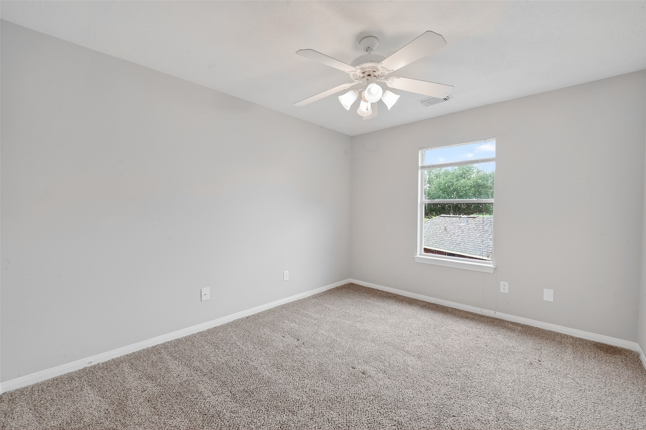 14308 Rocky Briar Lane Rosharon, TX 77583 - Photo 34 of 46 an empty room with a chandelier fan and windows