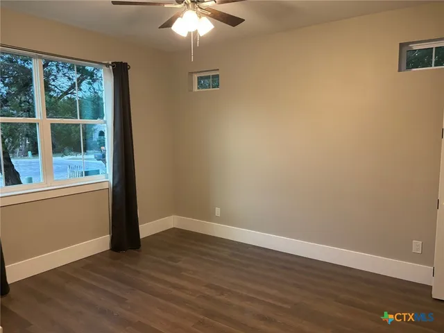 a living room with furniture and a mirror