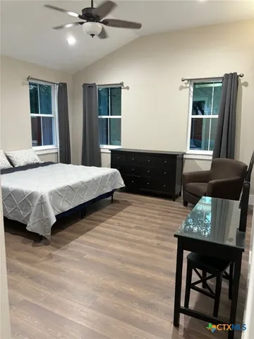 a bedroom with furniture and a window