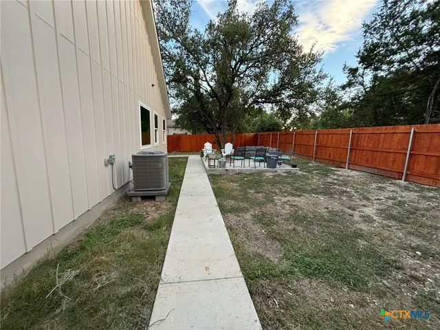 a view of a backyard with sitting area