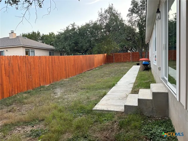 a backyard of a house with yard and outdoor seating