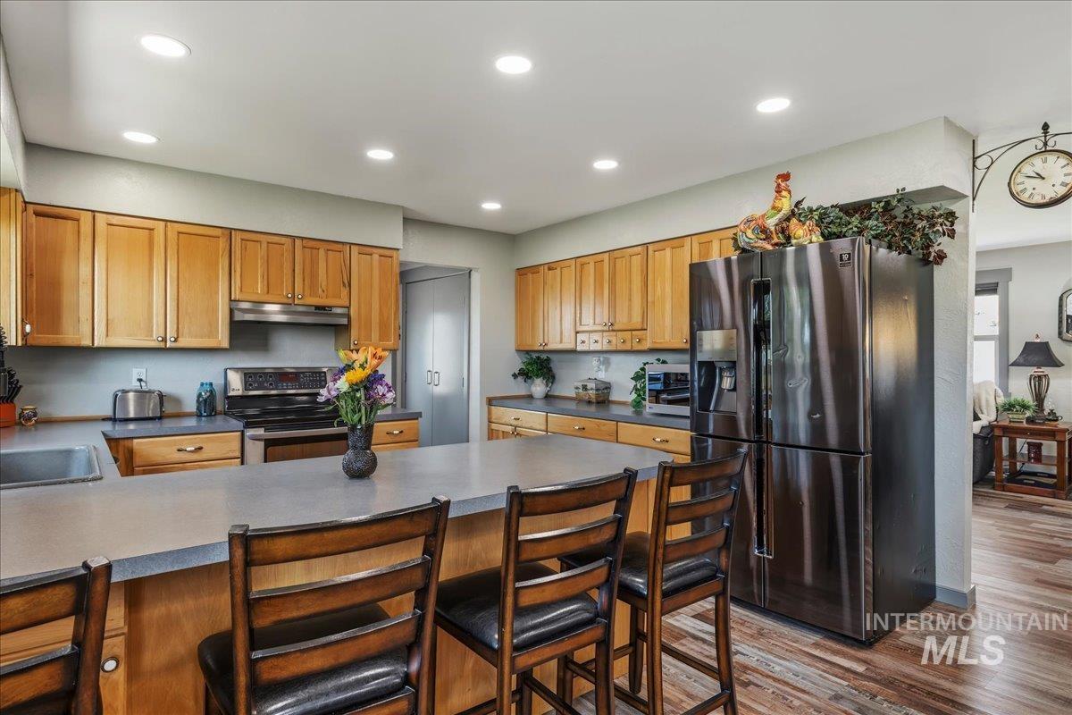 6323 Foothill Road Star, ID 83669 - Photo 13 of 50 Kitchen featuring wood cabinetry, stainless steel appliances, recessed ceiling lights, and an island with bar seating