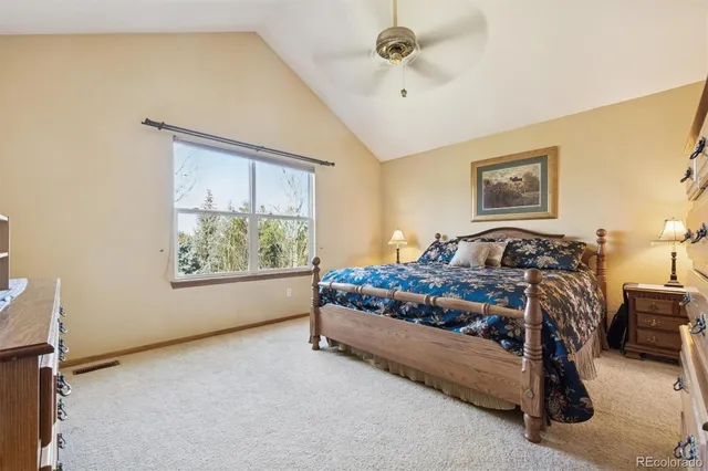 a spacious bedroom with a bed and cabinets
