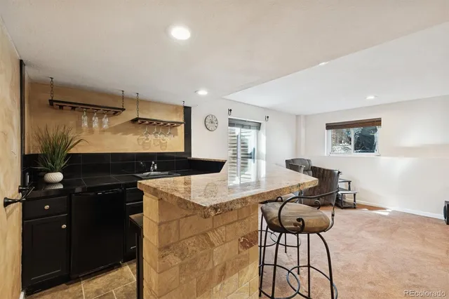 a view of a dining room with furniture and a large window