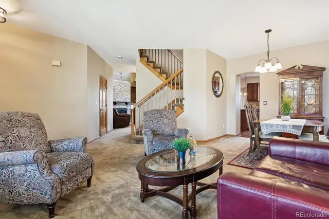 a living room with furniture and a chandelier