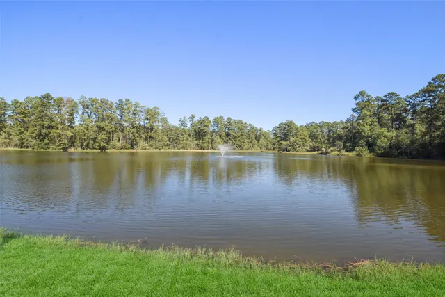 a view of a lake with houses in the back