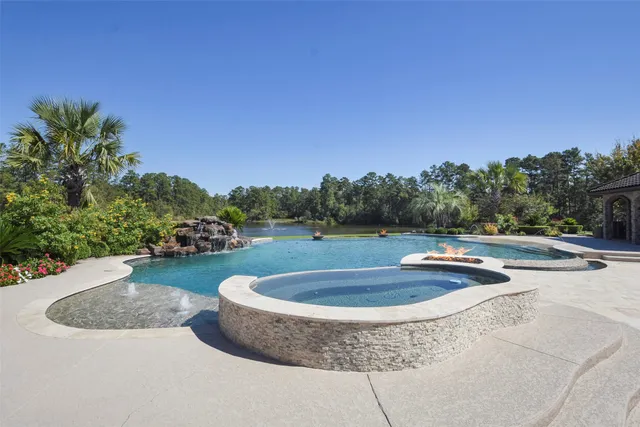 a view of a house with swimming pool and a yard