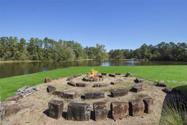 a view of a lake with a table and chairs