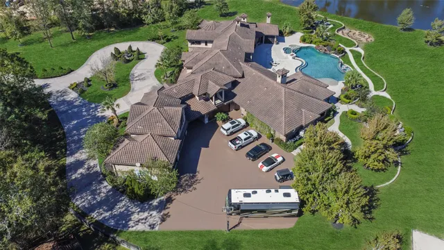 an aerial view of a house with a garden and outdoor seating