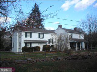 a front view of house with a garden