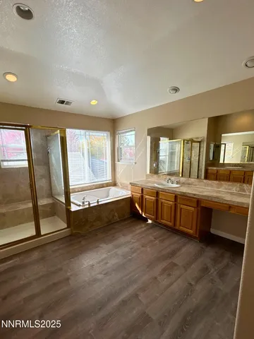 a bathroom with double vanity and a large window