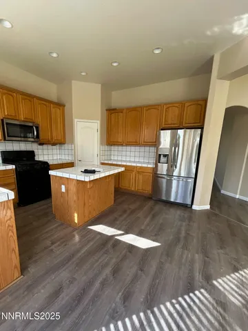 a view of kitchen with sink microwave and refrigerator