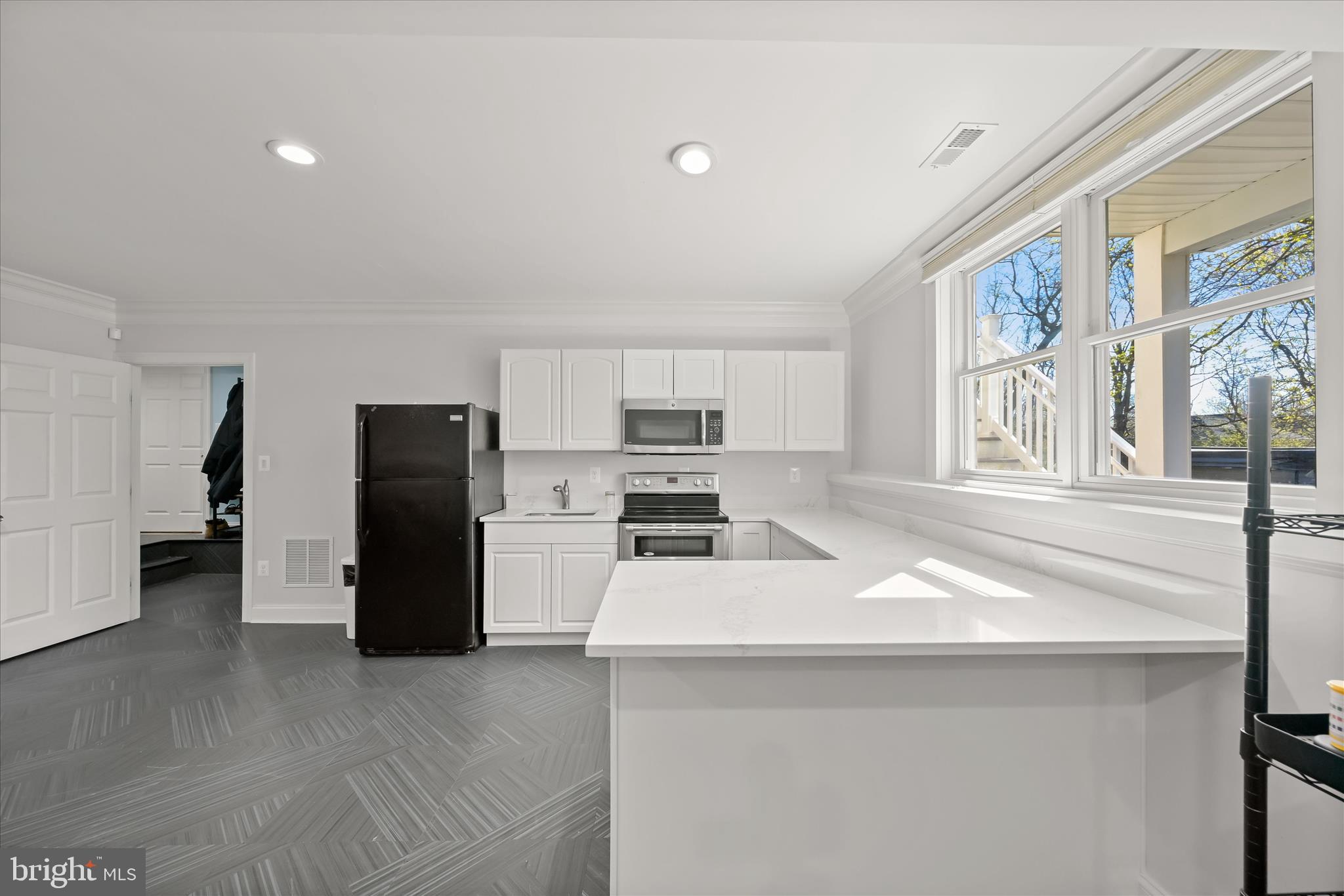 14865 Bushy Park Road Cooksville, MD 21723 - Photo 18 of 39 a kitchen with stainless steel appliances a refrigerator a stove a microwave and a refrigerator