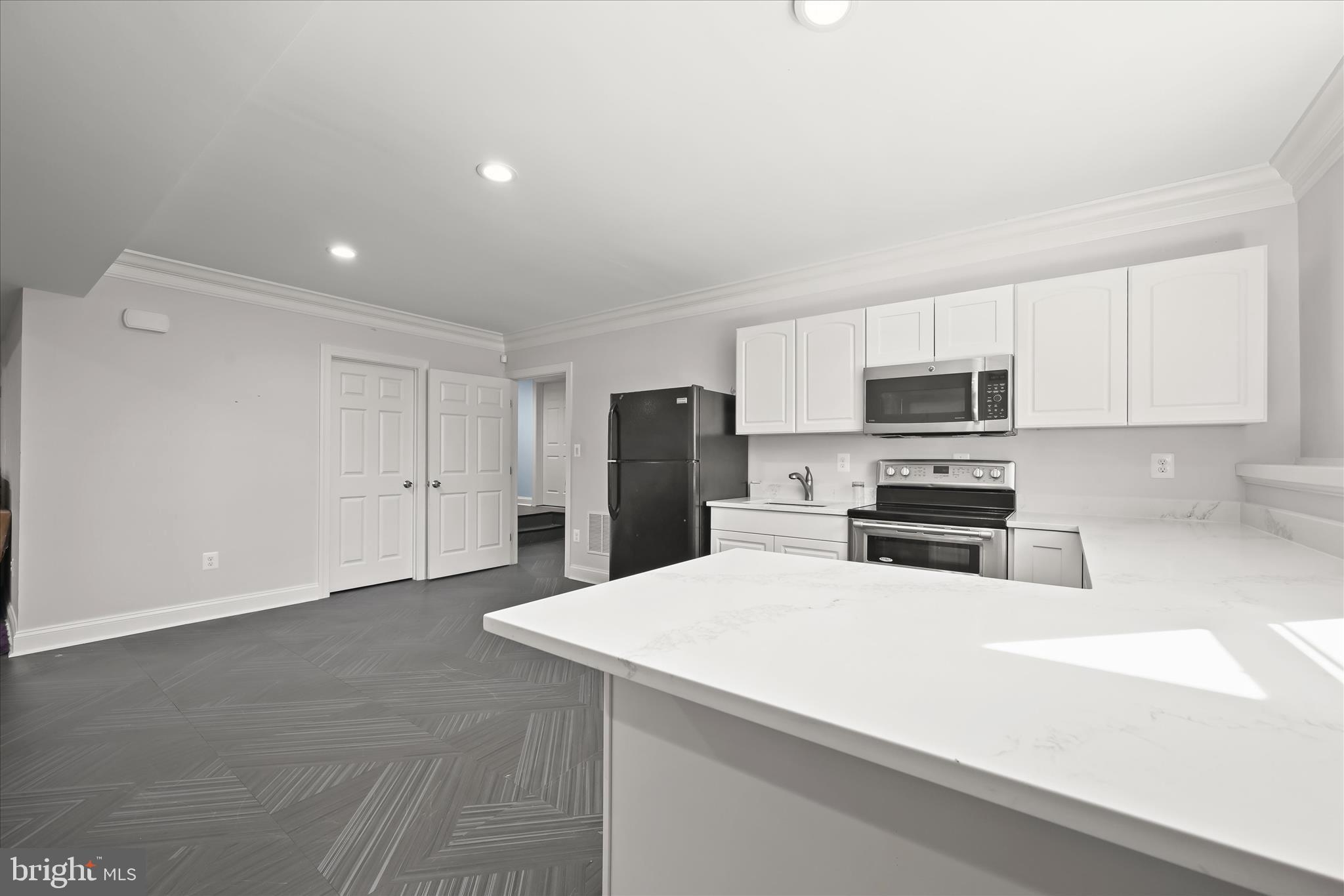 14865 Bushy Park Road Cooksville, MD 21723 - Photo 20 of 39 a kitchen with refrigerator and microwave