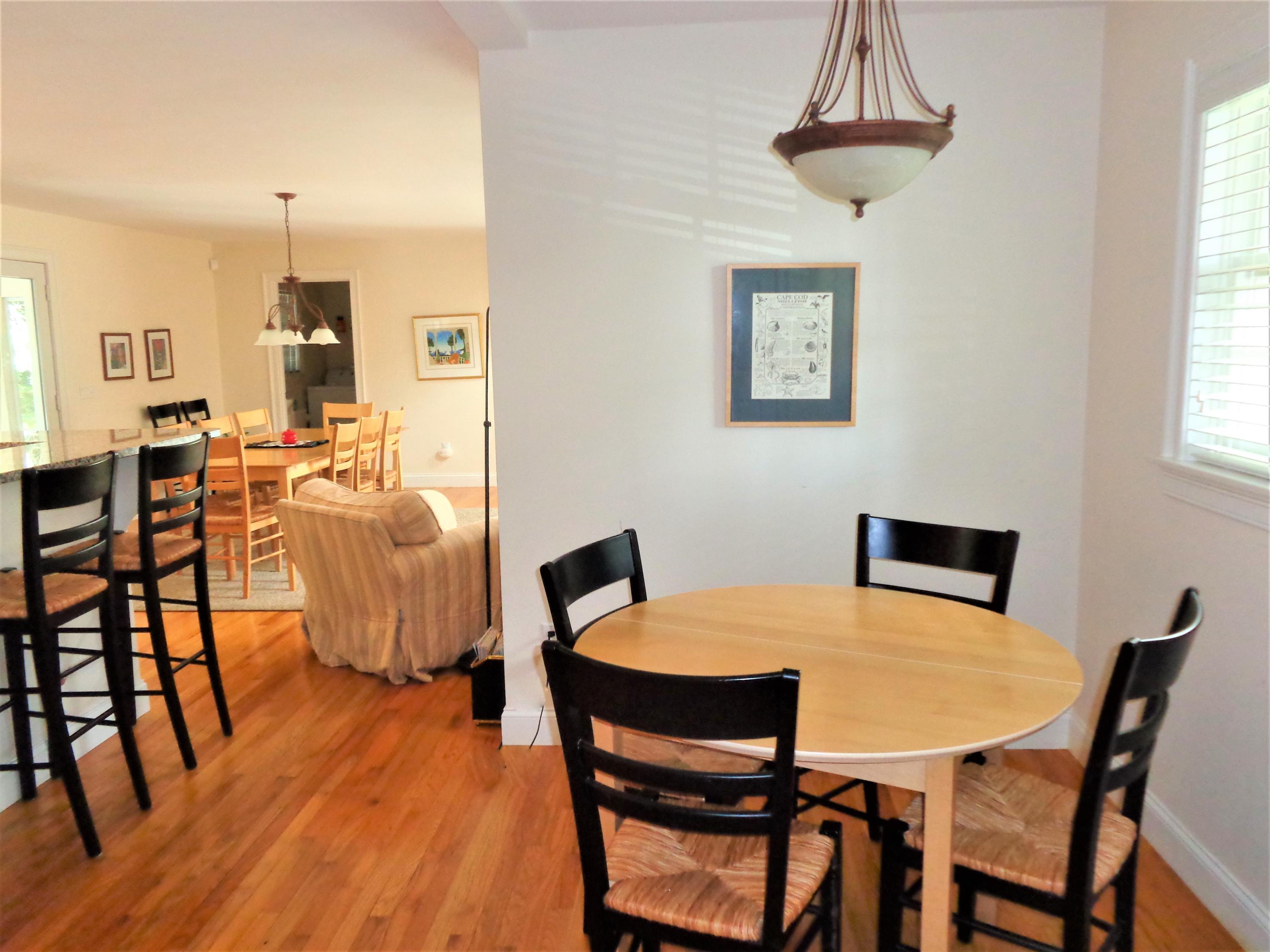 260 Pilgrim Spring Road Wellfleet, MA 02667 - Photo 8 of 39 a view of a dining room with furniture window and wooden floor