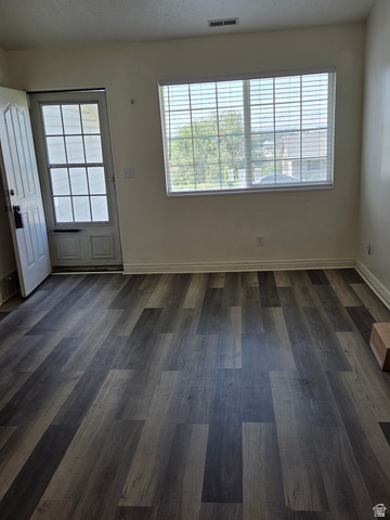 2159 Dakota Avenue Provo, UT 84606 - Photo 3 of 3 Spacious room featuring wood-finish flooring, a large window with blinds, and a paneled entry door