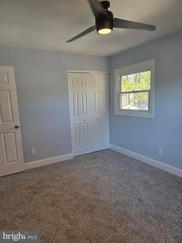 a view of an empty room with a ceiling fan
