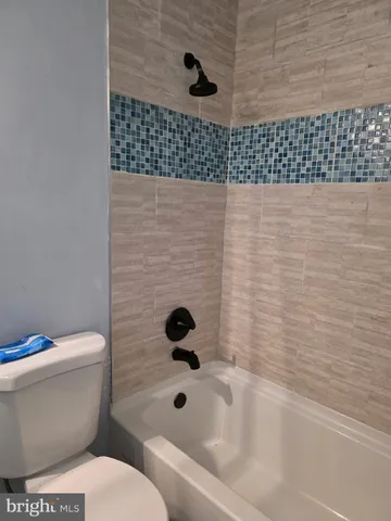 a living room with furniture and a potted plant on table