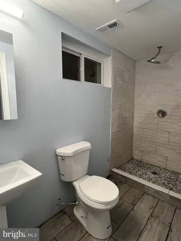 an empty room with closet and a chandelier fan