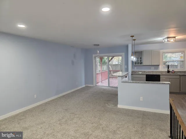 a large kitchen with kitchen island a sink stove and granite countertops