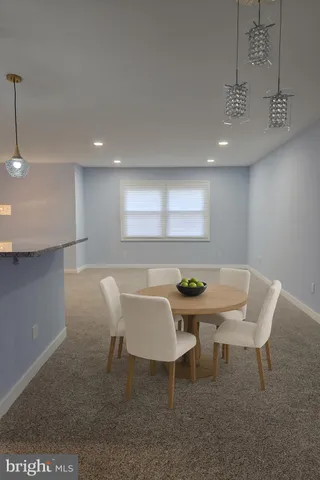 a view of an empty room with windows & cabinet