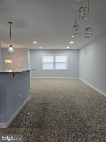 a kitchen with stainless steel appliances granite countertop a sink stove a refrigerator and cabinets