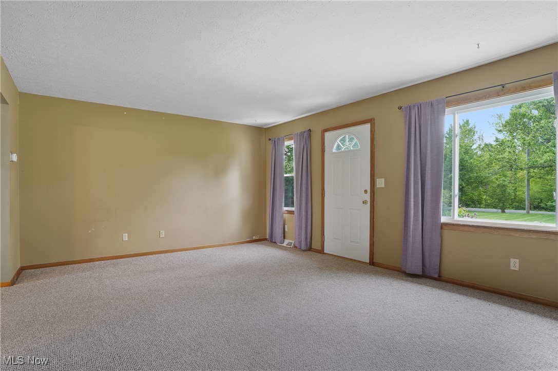 12395 Carter Road Painesville, OH 44077 - Photo 22 of 39 Foyer featuring light colored carpet and baseboards