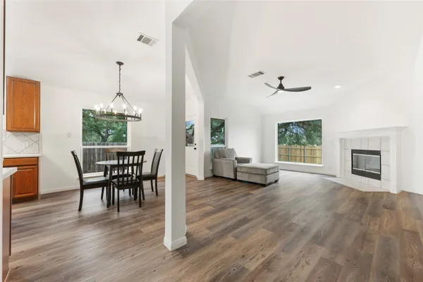 a view of a dining room with furniture and wooden floor