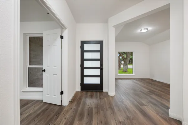 a view of a room with wooden floors closet and windows