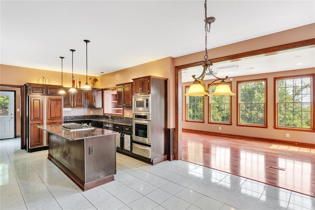 117 Olde Manor Lane Coraopolis, PA 15108 - Photo 9 of 23 a kitchen with stainless steel appliances granite countertop a stove and a refrigerator