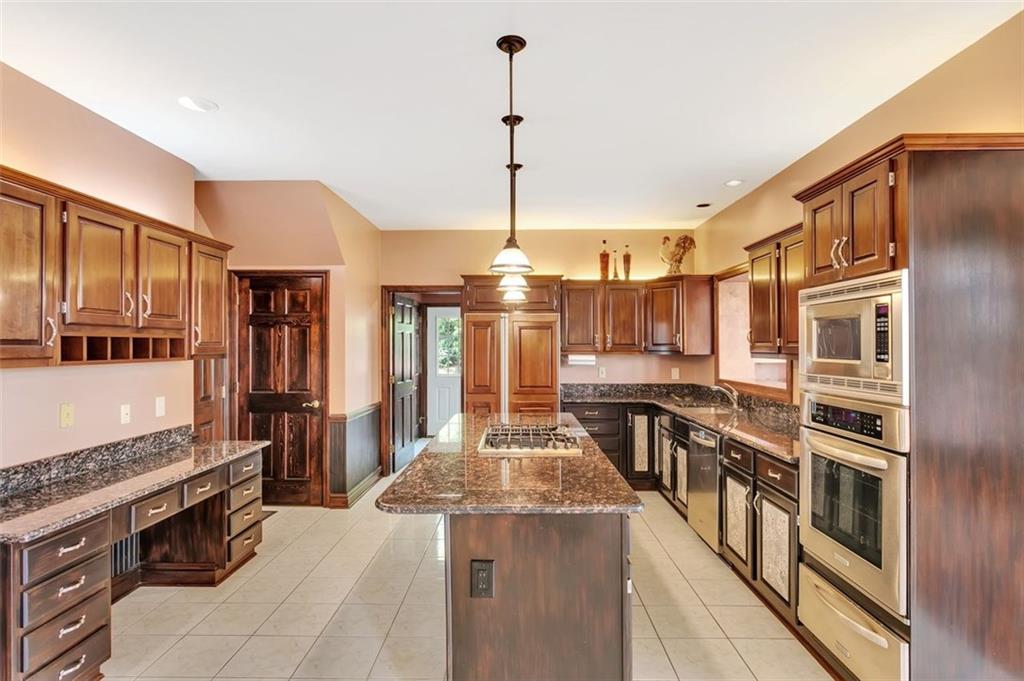 117 Olde Manor Lane Coraopolis, PA 15108 - Photo 10 of 23 a kitchen with stainless steel appliances granite countertop a stove and a refrigerator