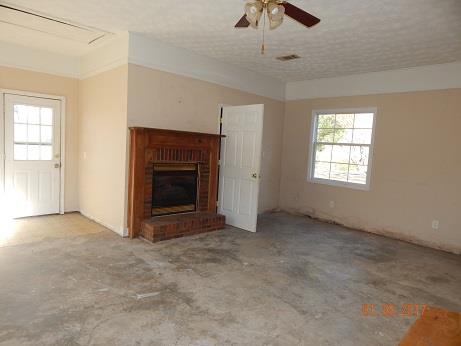 497 Revilo Road Leoma, TN 38468 - Photo 3 of 10 an empty room with windows and fireplace