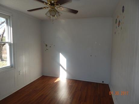 497 Revilo Road Leoma, TN 38468 - Photo 7 of 10 an empty room with wooden floor fan and windows