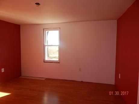 497 Revilo Road Leoma, TN 38468 - Photo 8 of 10 an empty room with wooden floor and windows