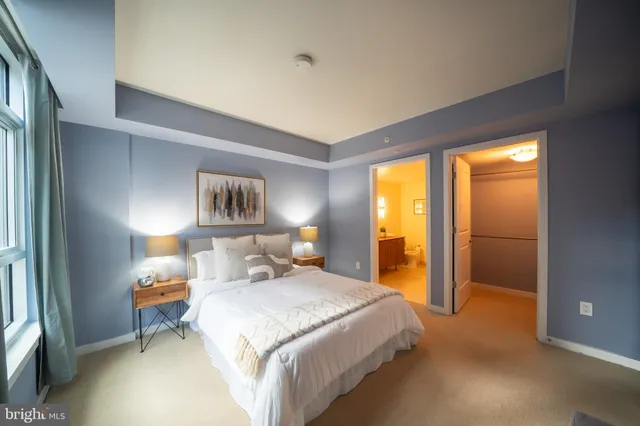 a bedroom with a bed and a lamp on table