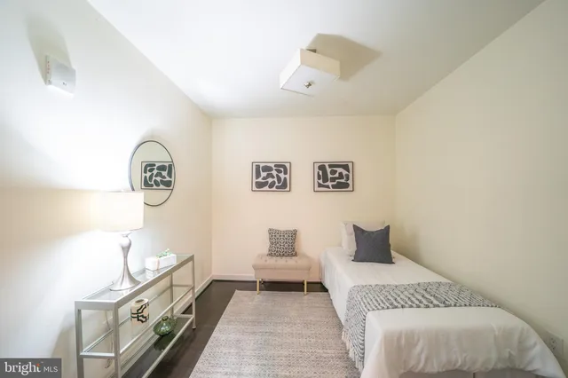 a bedroom with a bed and painting on the wall