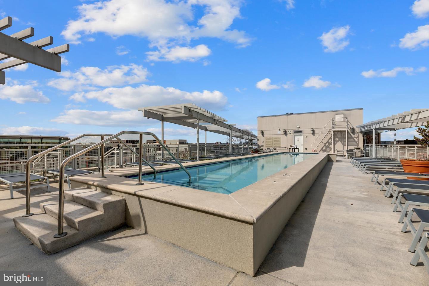 1025 First Street Southeast, Unit 611 Washington, DC 20003 - Photo 23 of 36 a view of a swimming pool with a lounge chair