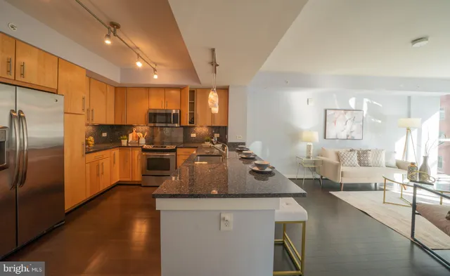 a kitchen with counter top space a sink appliances and cabinets