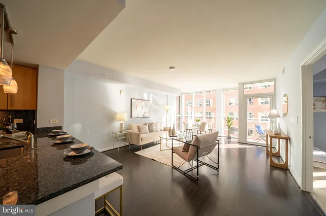 a living room with furniture and a flat screen tv with wooden floor