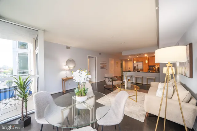 a dining room with furniture a livingroom and chandelier