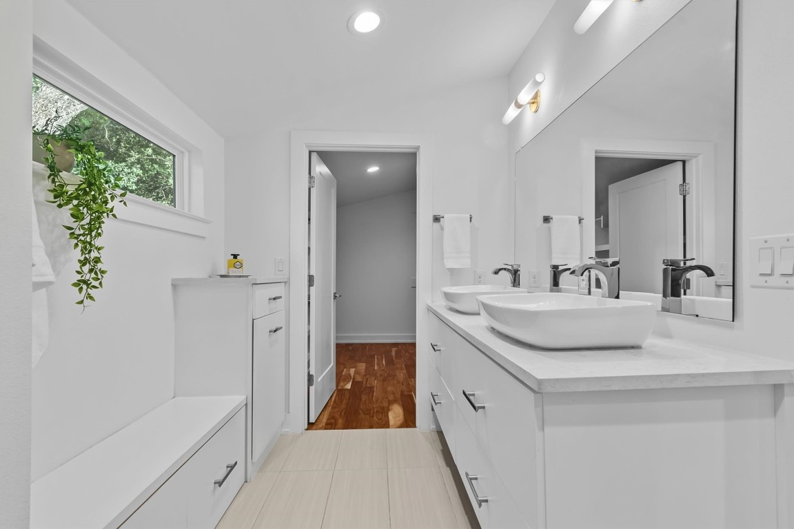 2712 Oak Springs Drive, Unit A Austin, TX 78702 - Photo 22 of 34 a spacious bathroom with a double vanity sink a mirror and a bathtub
